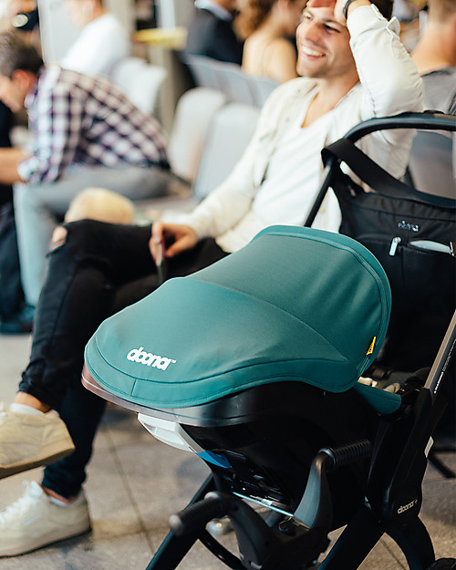 Doona Doona+, Seggiolino Auto Gruppo 0+ con Ruote 2-in-1, Verde Racing - Approvato come passeggino! Seggiolini Auto Gruppo 0+/1